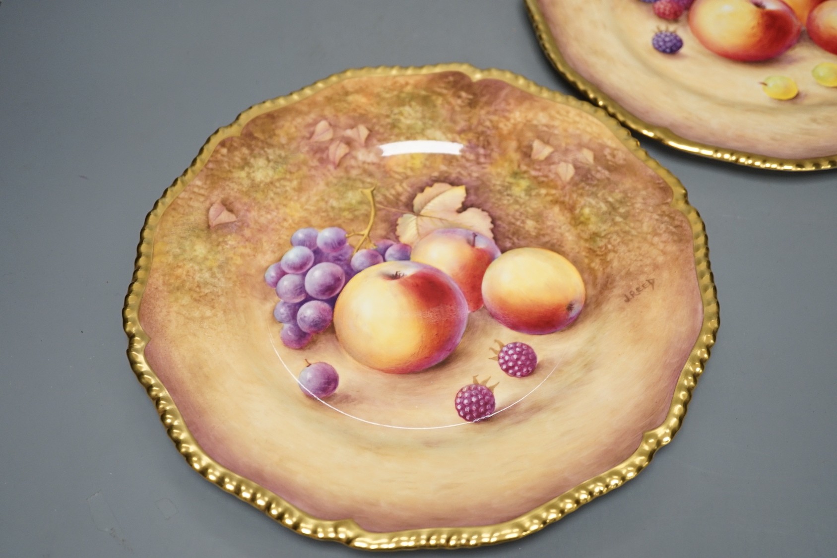 A pair of Royal Worcester fruit painted dinner plates, post war, by J. Reed, 27cm diameter